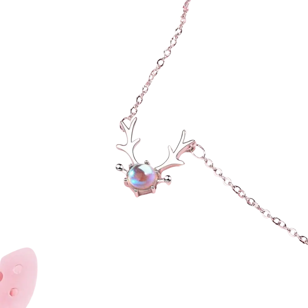 Sterling silver deer antler necklace featuring a central iridescent moonstone pendant in silver tone