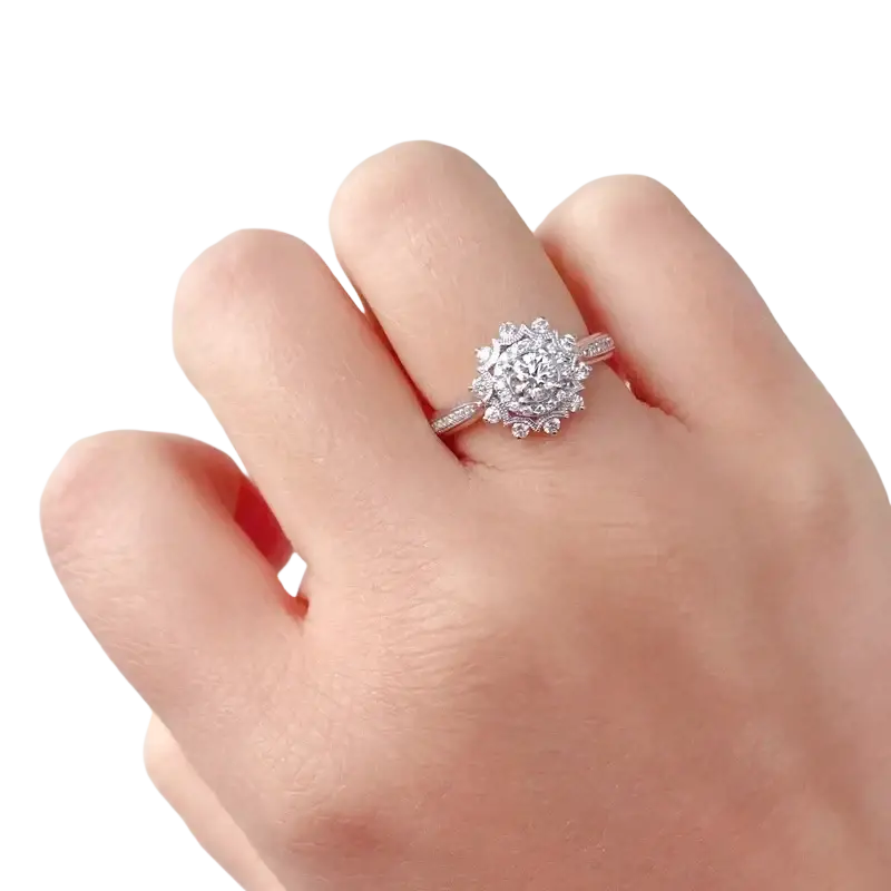 A sterling silver engagement wedding ring with a central round-cut diamond surrounded by smaller stones