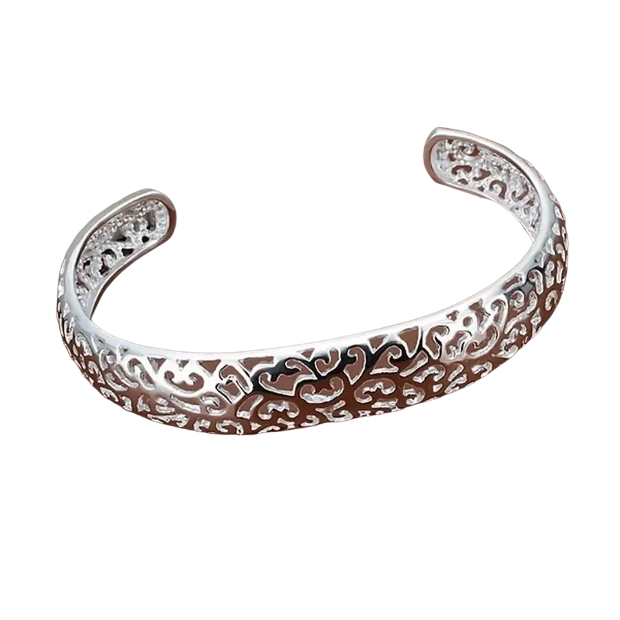 Sterling silver open cuff bracelet with intricate filigree design and heart motifs in elegant silver tone