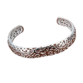 Sterling silver open cuff bracelet with intricate filigree design and heart motifs in elegant silver tone