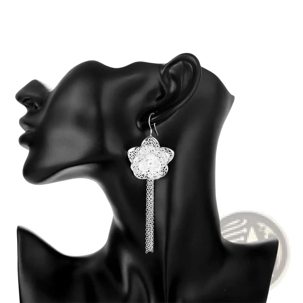 Sterling silver flower earring with intricate filigree design and dangling chain from a sterling silver jewelry set