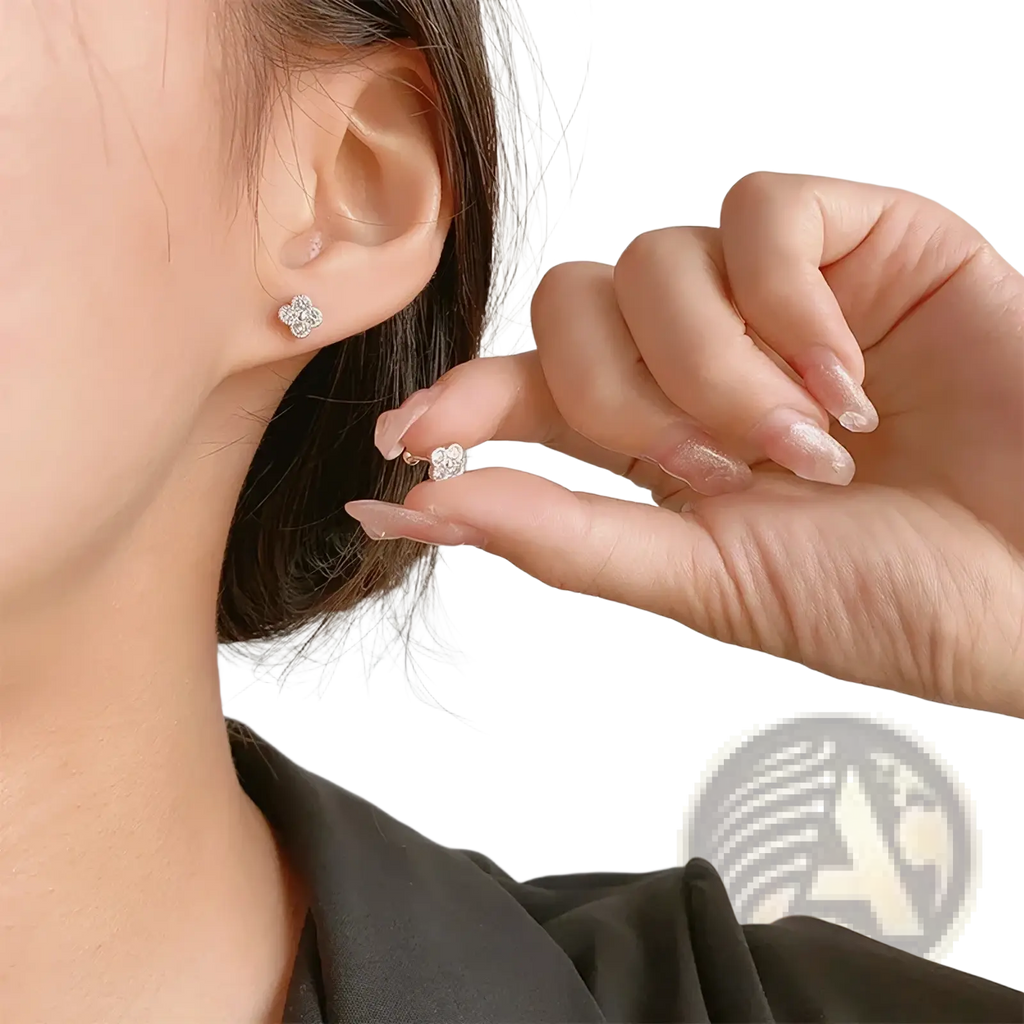 Sterling silver four stone flower stud earrings with delicate four-petal design and clear sparkling crystals