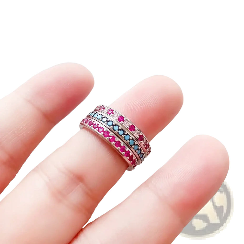 Sterling silver stacked ring featuring vibrant pink and blue gemstones set in a sleek silver band