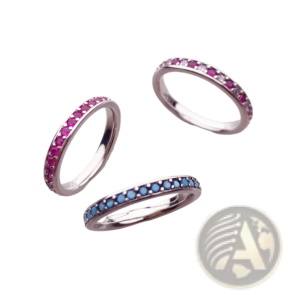 Sterling silver gemstone stacked rings with continuous bands of pink ruby, blue sapphire, and clear stones