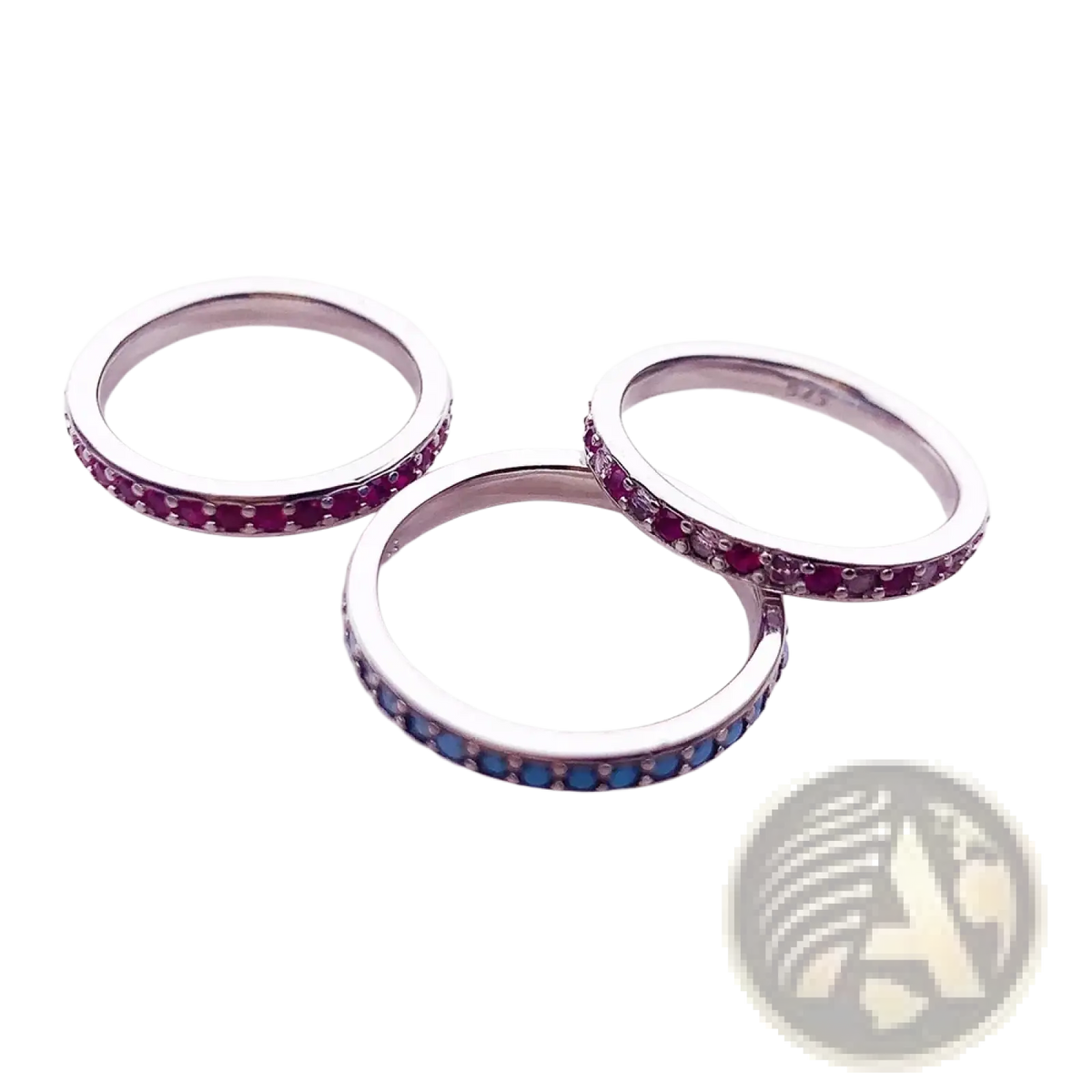Three sterling silver gemstone stacked rings featuring continuous bands of vibrant red and blue stones
