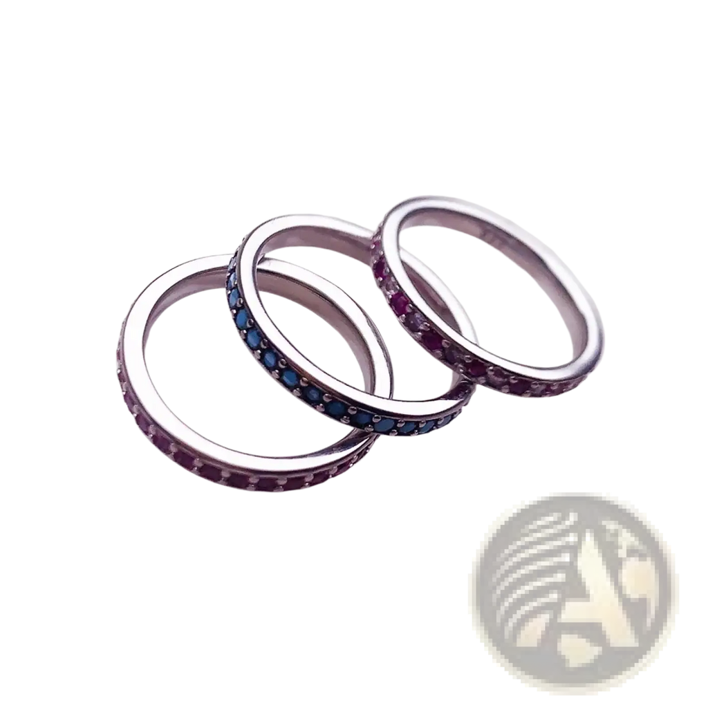Sterling silver stacked ring set with continuous rows of tiny blue and red gemstones along the inner edge