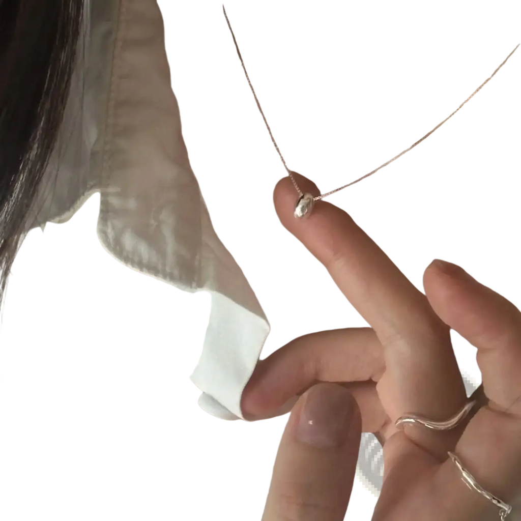 Sterling silver geometric pendant necklace with delicate silver chain and small heart-shaped textured pendant