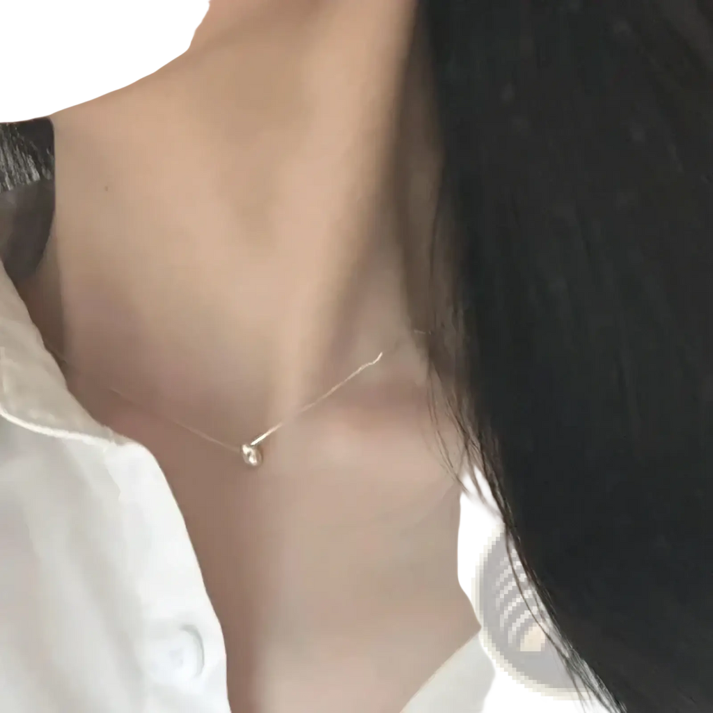 Sterling silver geometric pendant necklace featuring a gold-toned delicate chain with a small pearl pendant