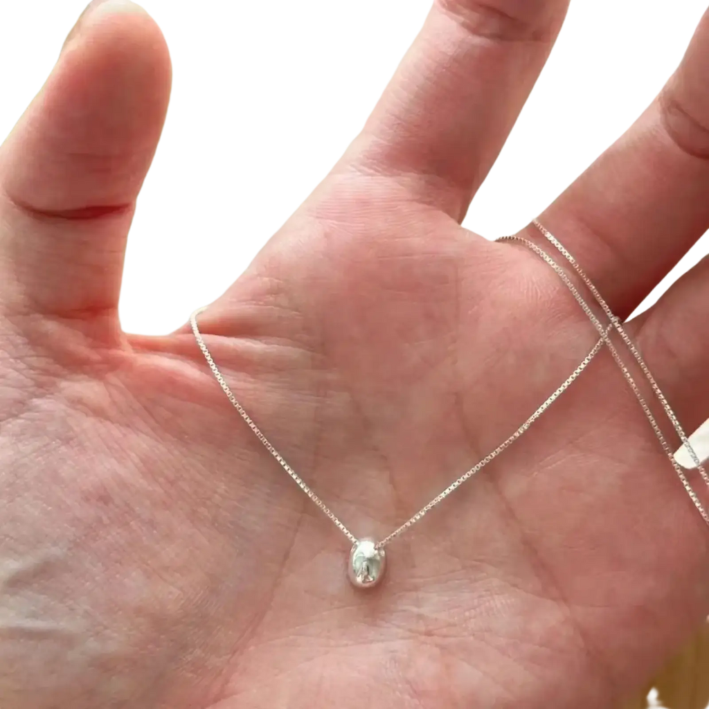 Sterling silver geometric pendant necklace with a delicate oval polished pendant and fine chain in silver color