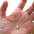 Sterling silver geometric pendant necklace with a delicate oval polished pendant and fine chain in silver color