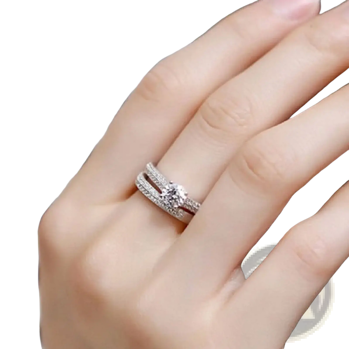 Sterling silver halo wedding ring set with a delicate silver-toned engagement ring featuring a central round-cut diamond and pave-set diamond bands