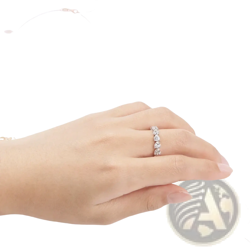 Sterling silver heart eternity ring with a delicate band featuring five round-cut sparkling diamonds in a line