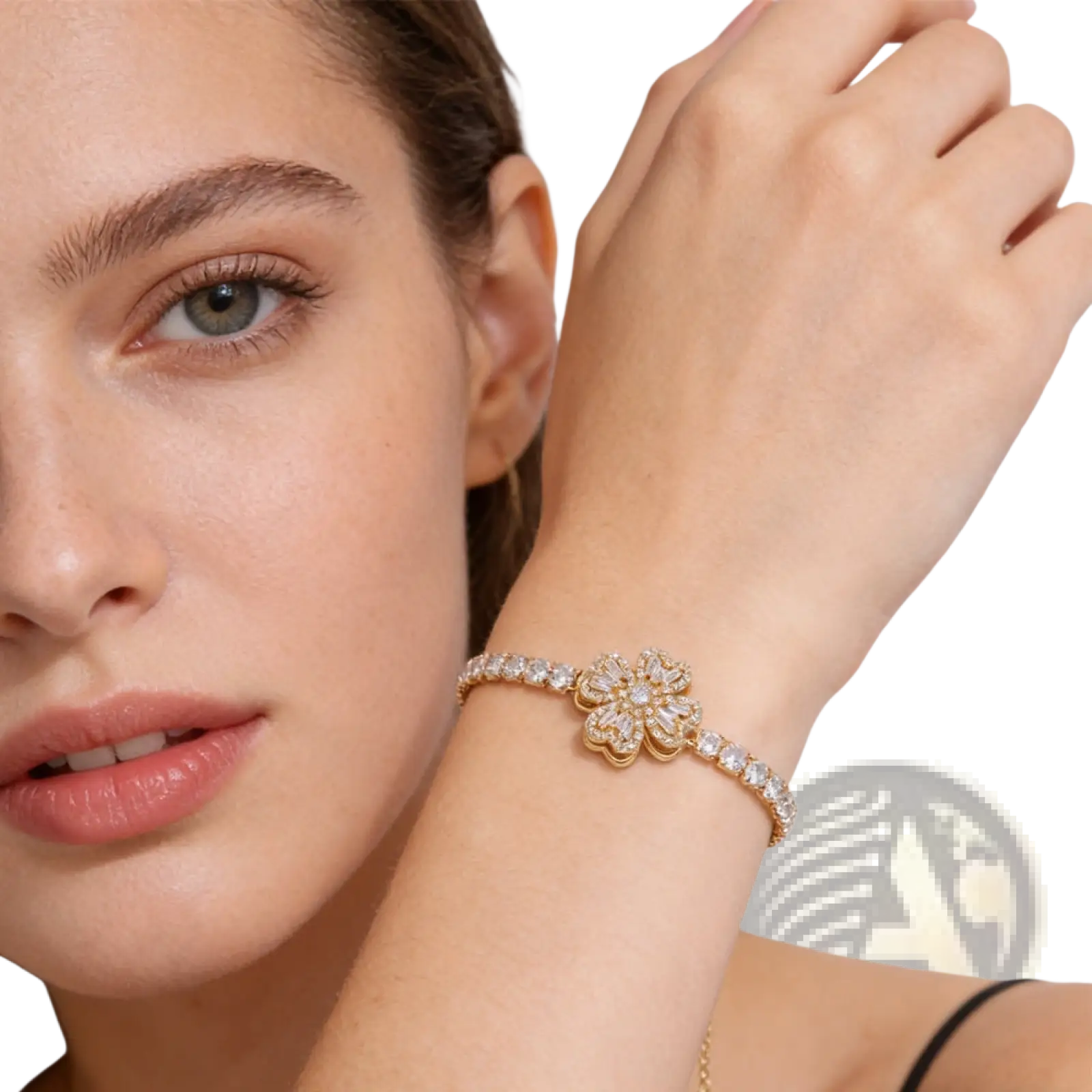 Gold-toned bracelet with central floral design and clear stones, featuring a delicate chain in sterling silver infinity heart style