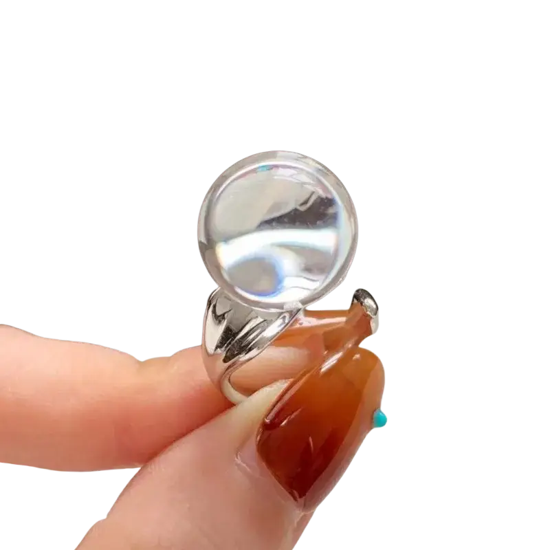 A sterling silver ring for women featuring a large clear gemstone in a minimalist curved band design