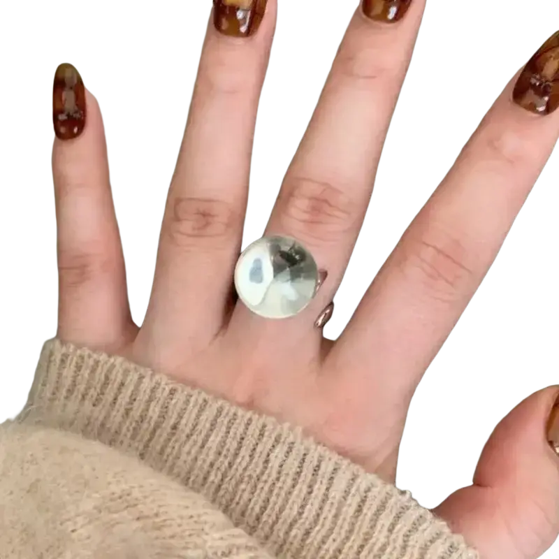 A sleek sterling silver ring for women featuring a minimalist round ball design with a smooth reflective surface