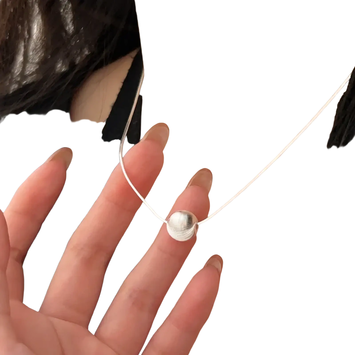 Sterling silver pendant necklace with a minimalist smooth round disc charm and a delicate silver snake chain