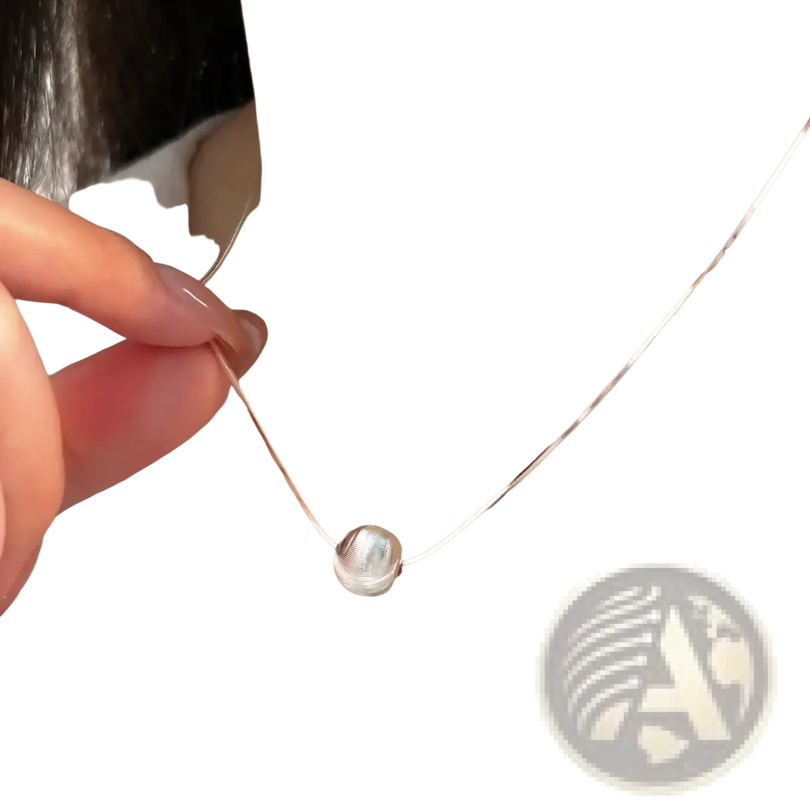 A sleek sterling silver pendant necklace with a textured silver spherical pendant on an elegant chain