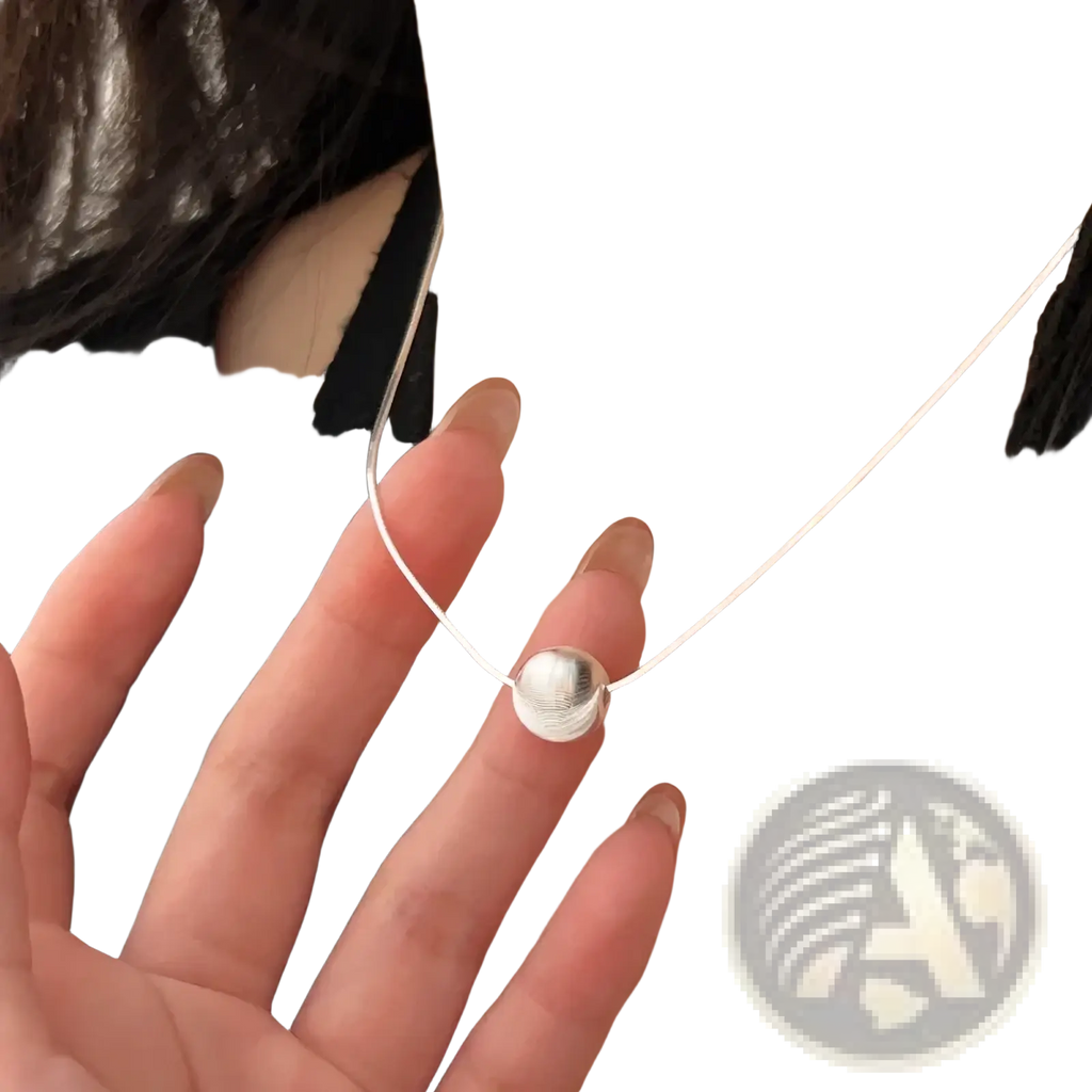 Sterling silver pendant necklace with a minimalist smooth round disc charm and a delicate silver snake chain