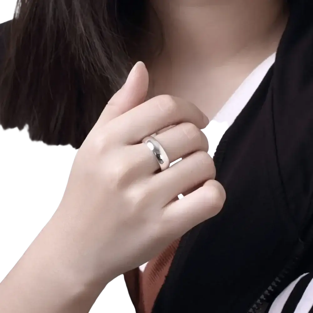 A high quality sterling silver ring minimalist starburst band in silver worn on the ring finger with a smooth finish