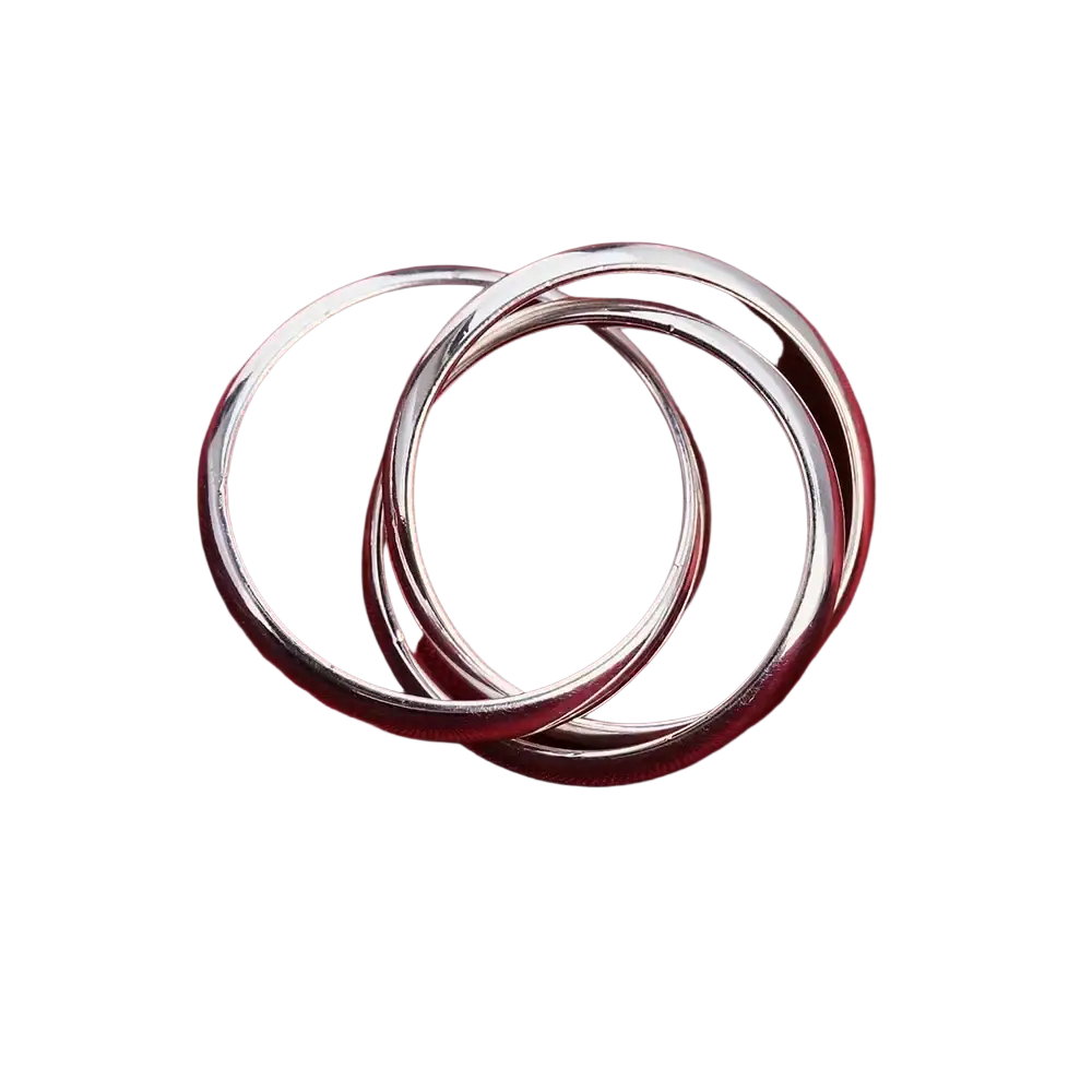 Three interlocking sterling silver rings with a smooth polished finish rest on red fabric in women simple three circles design