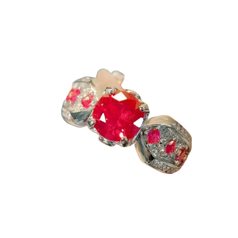 Sterling silver ruby gemstone ring for women with a faceted red ruby center and smaller ruby and diamond clusters