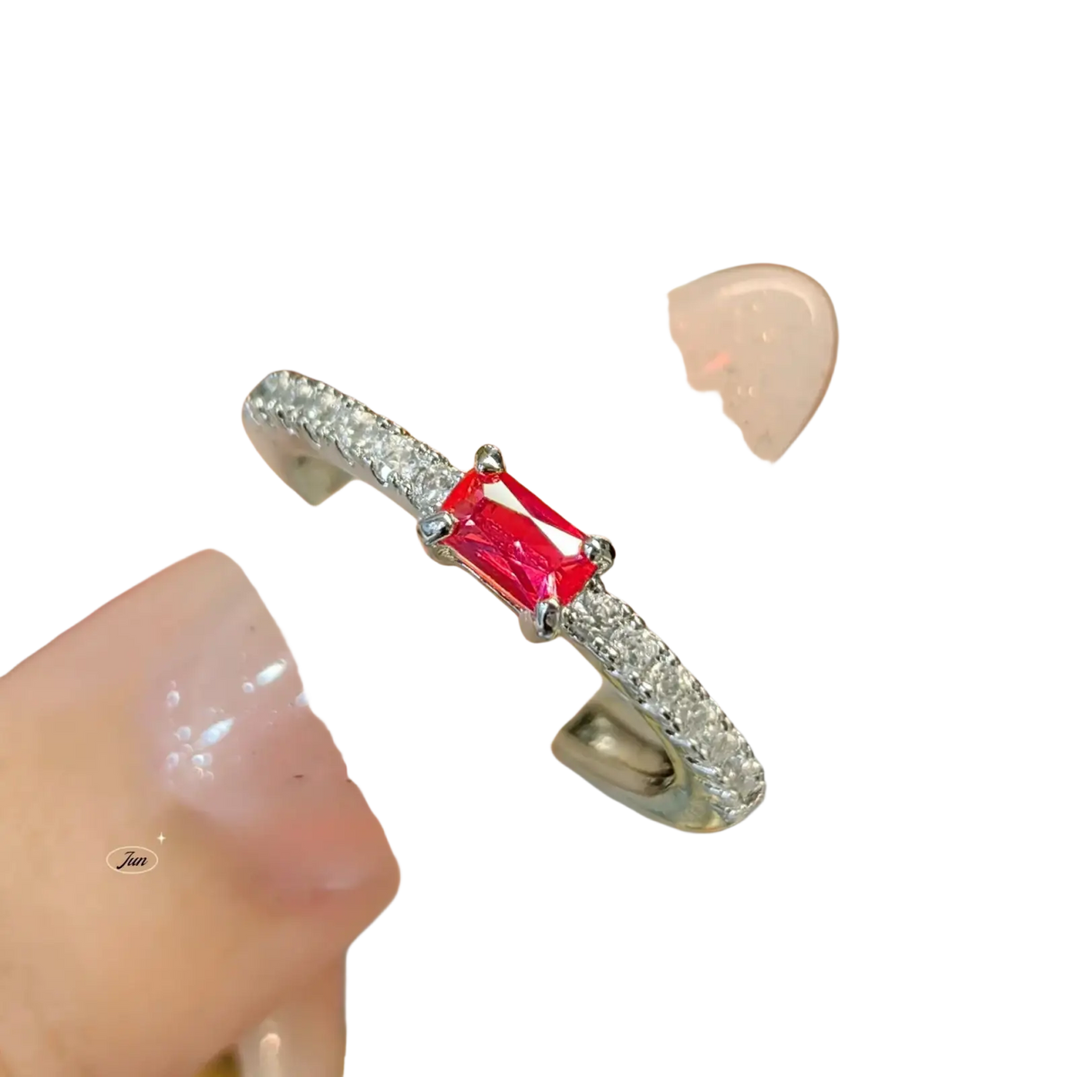 A sterling silver ring for women with a vibrant red emerald-cut ruby gemstone surrounded by clear pavé diamonds
