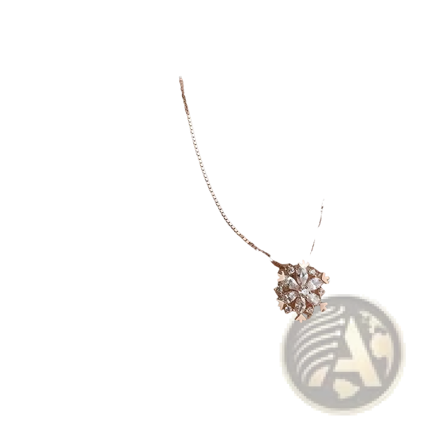 Sterling silver snowflake pendant necklace set featuring a delicate rose gold pendant with clear crystals on beige fabric