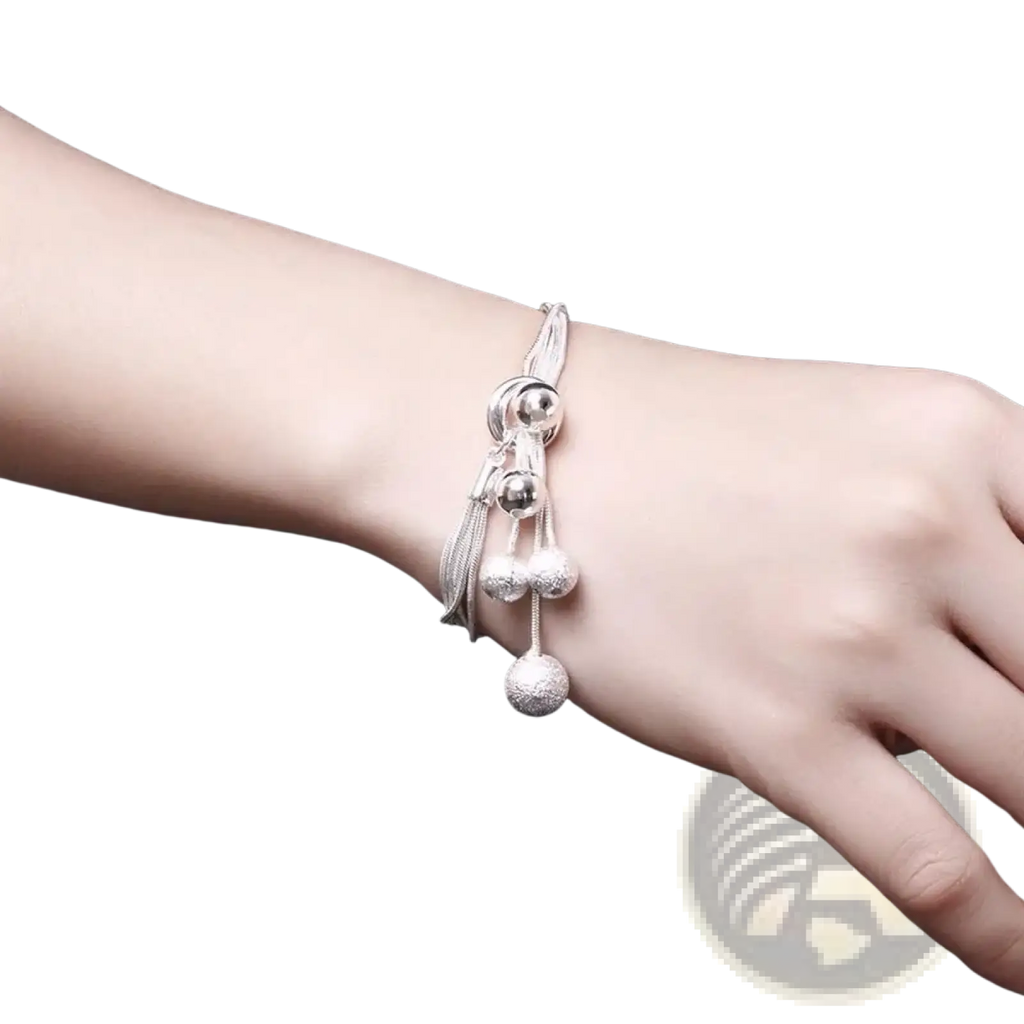 Sterling silver tassel bead jewelry set featuring a silver beaded bracelet with dangling spheres and tassels