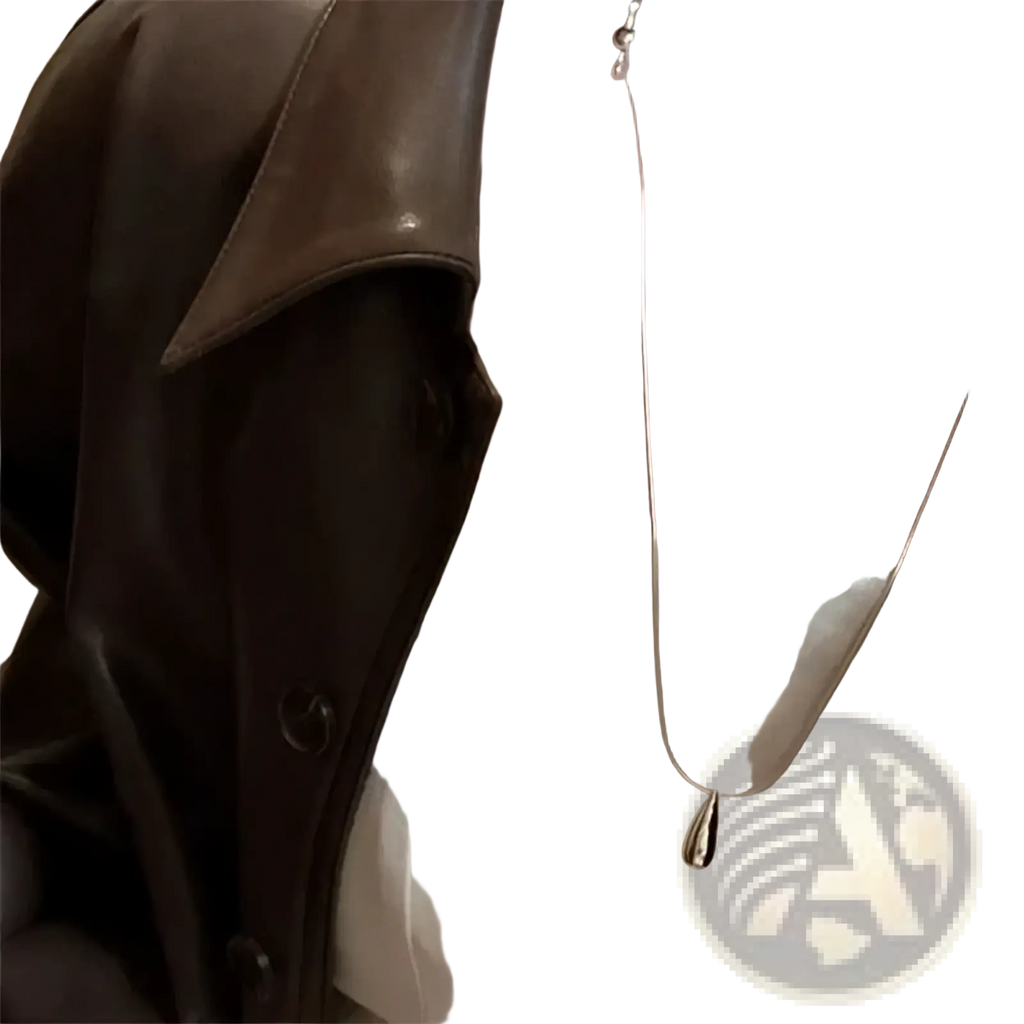 A sleek silver teardrop pendant necklace with a smooth minimalist design made of sterling silver fine jewelry