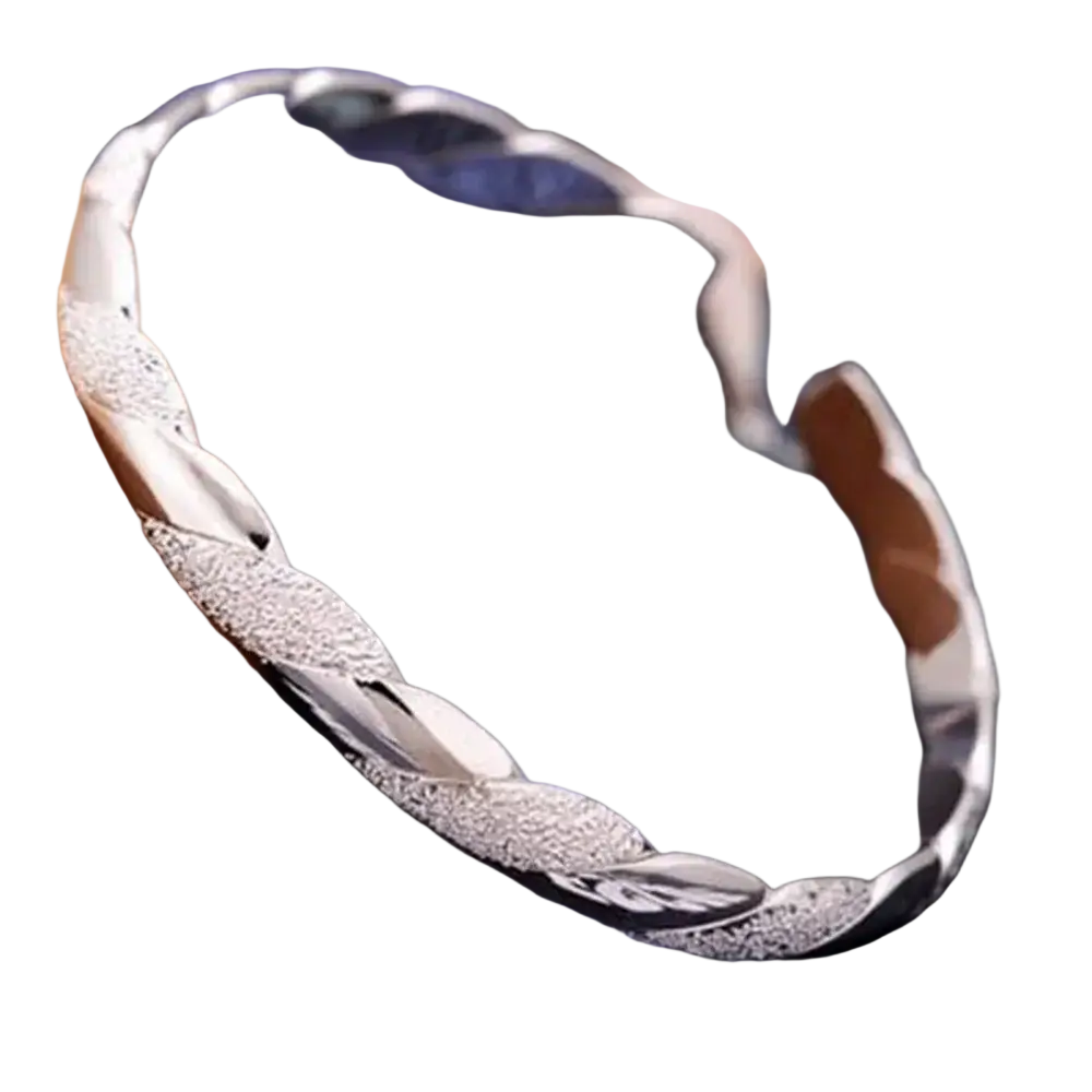 Sterling silver twisted bangle bracelet with silver braided textured leaf patterns and polished reflective finish