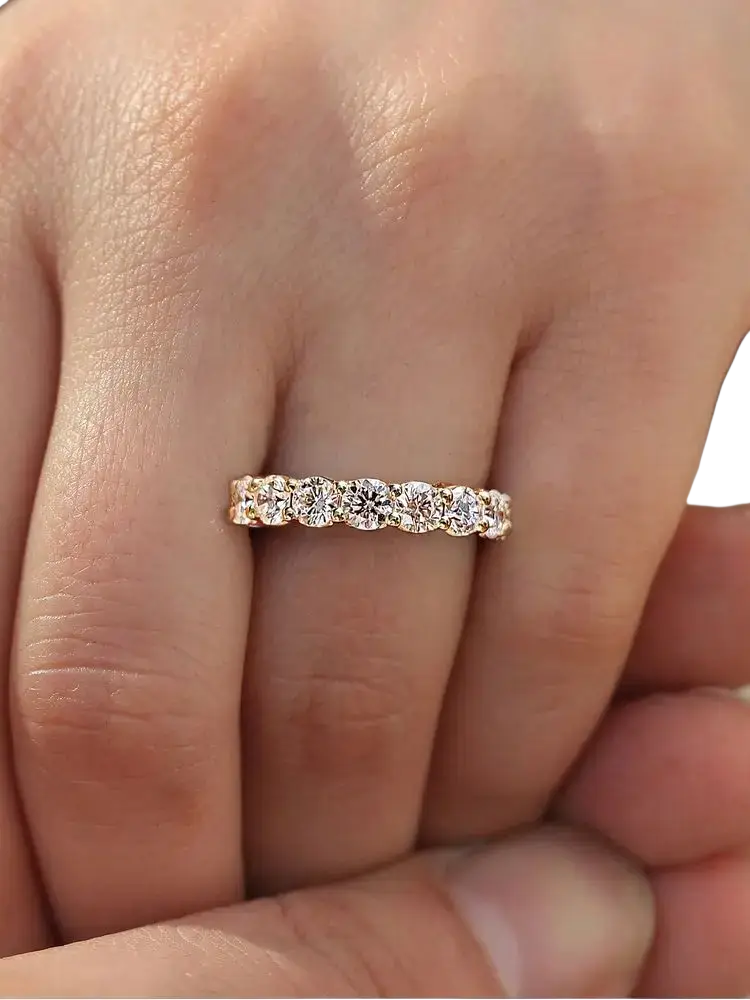 A sterling silver zircon wedding band for women with a delicate rose gold eternity design featuring round-cut diamonds