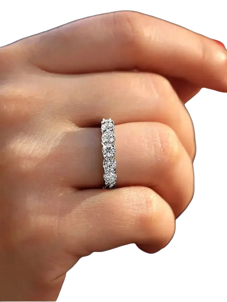 A sleek platinum band ring with five round-cut diamonds designed as a sterling silver zircon wedding band for women