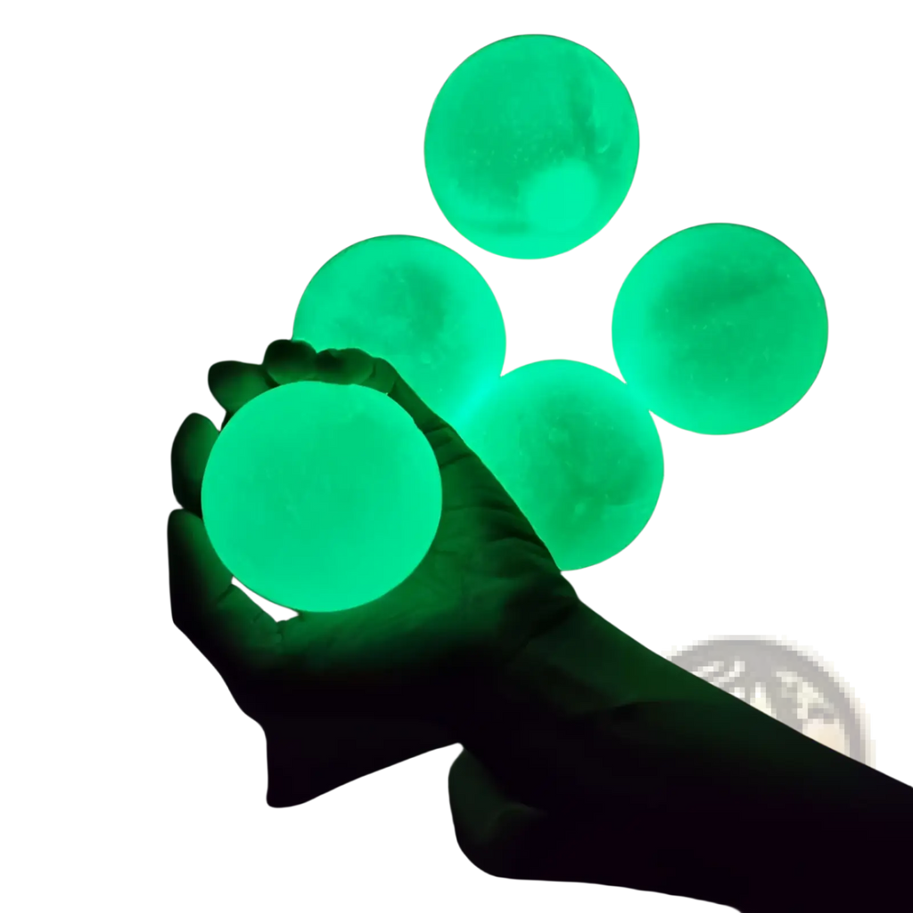 Glowing green sticky wall ball stress relief squash toys with textured matte finish for sensory play and relaxation