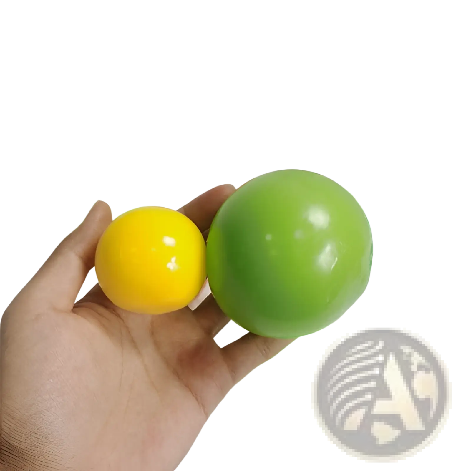 A hand holds vibrant yellow and glossy green 45mm sticky wall ball stress relief glow squash toys with colorful packaging nearby