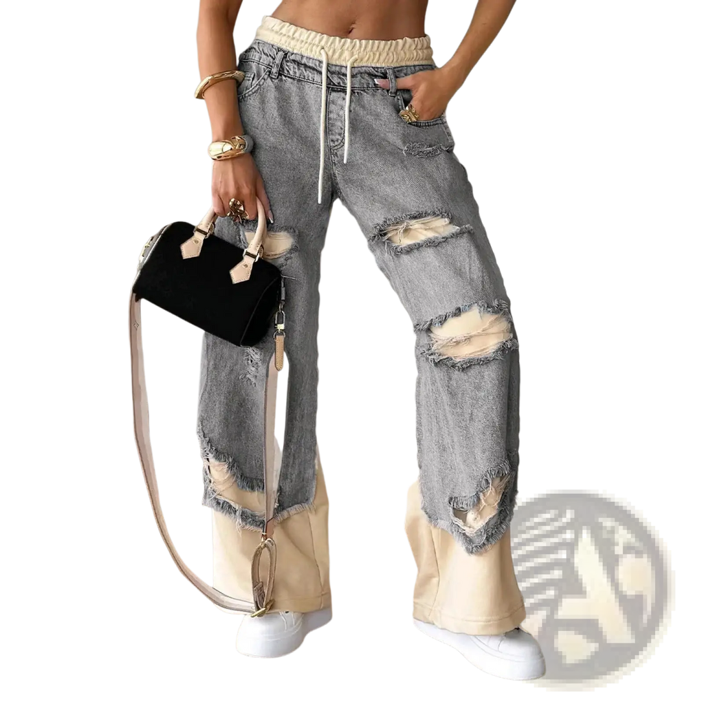 Stitched contrast denim streetwear jeans in distressed light-wash denim with ripped knees and cream elastic waistband