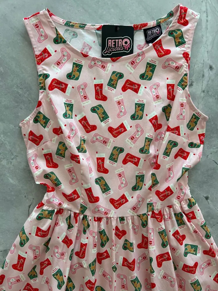 Pink sleeveless cotton dress with red and green Christmas stocking and reindeer pattern by Retro Licorice