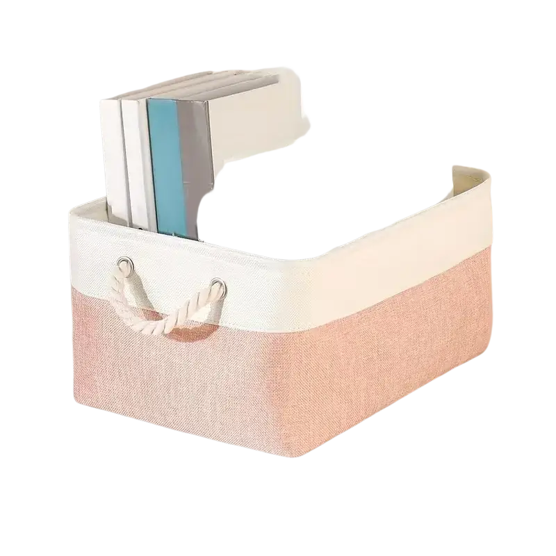 A soft blush-pink and white woven fabric storage basket with braided rope handle for foldable storage baskets