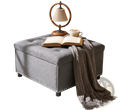 Gray tufted square storage ottoman with textured fabric finish and decorative nailhead trim along the base