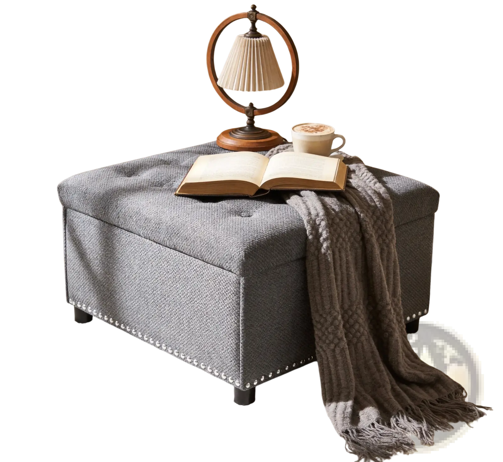 Gray tufted square storage ottoman with textured fabric finish and decorative nailhead trim along the base