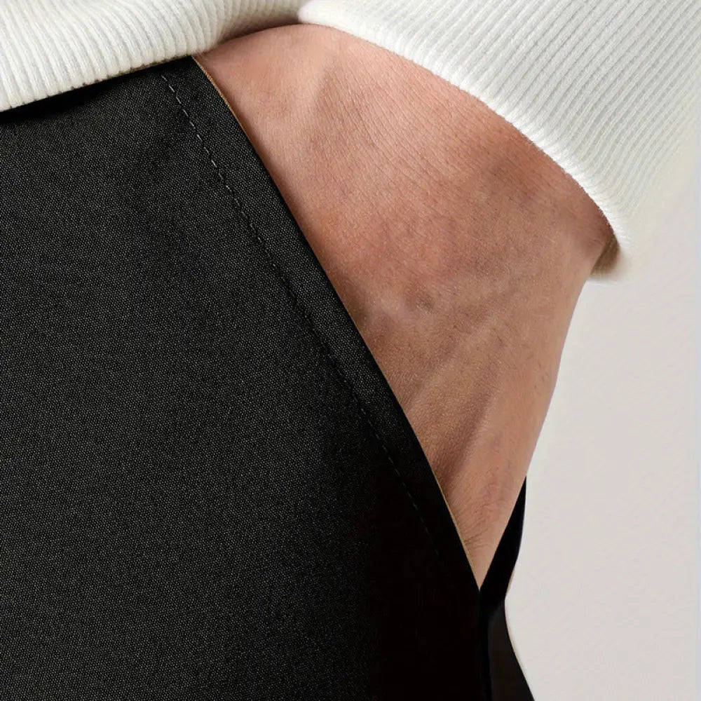 Black textured fabric men’s tactical wear resistant cargo joggers with pockets paired with ribbed white sweater cuff