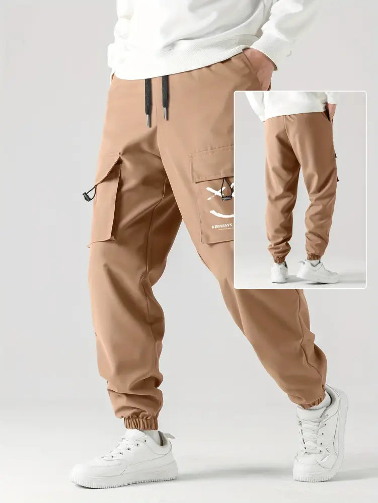 Tan men’s tactical wear resistant cargo joggers featuring multiple pockets and a drawstring waistband