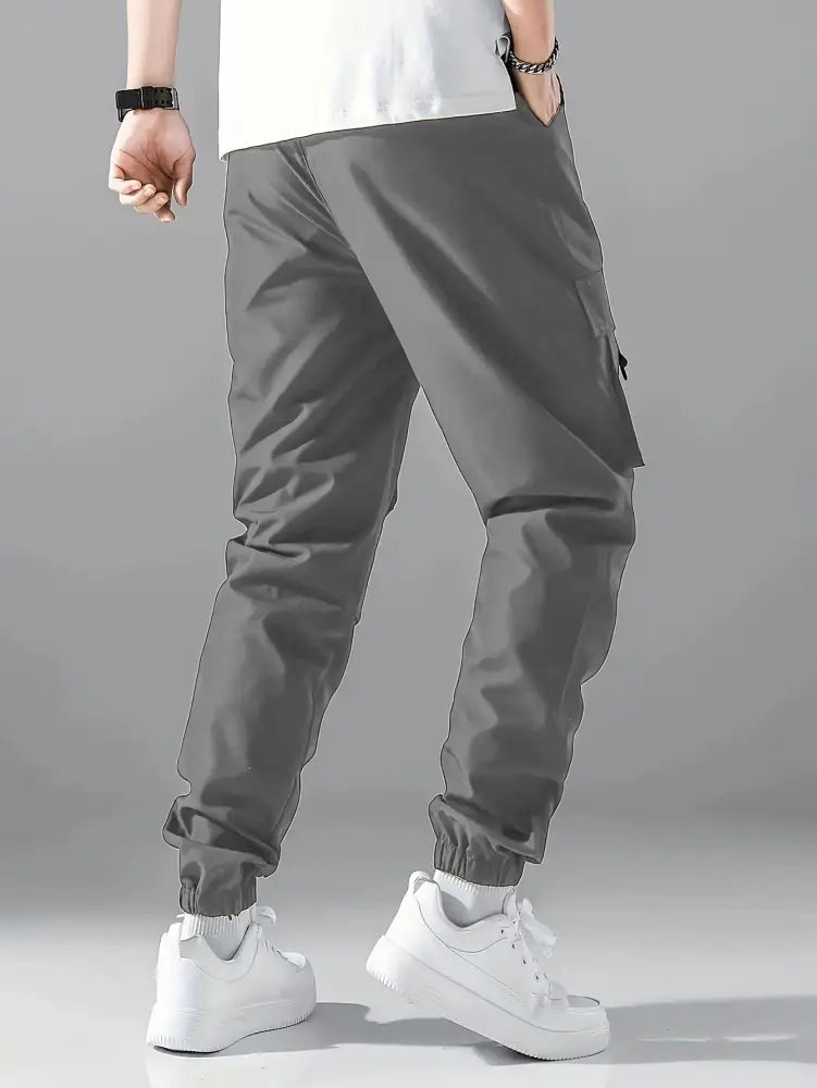 Men’s gray tactical wear resistant cargo joggers with elastic cuffs and spacious side pockets for durability and utility