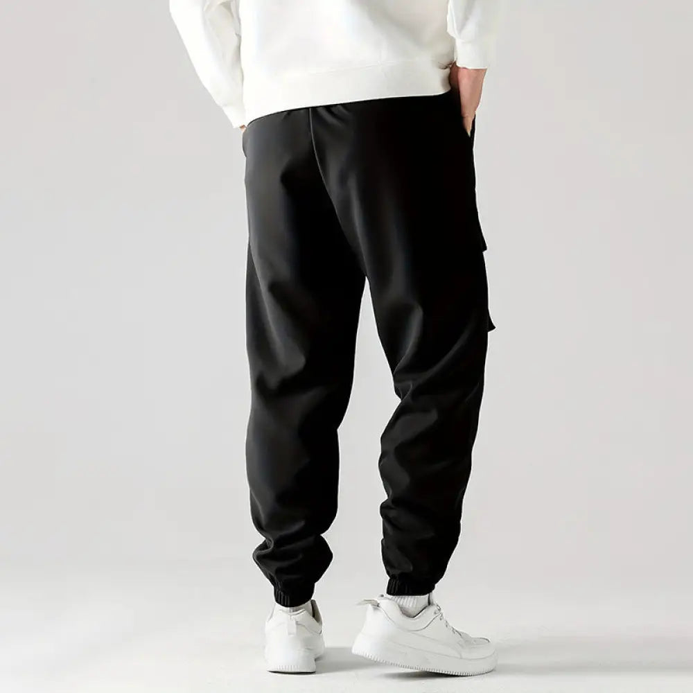 Men’s black tactical wear resistant cargo joggers with elastic cuffs and multiple side pockets for utility use