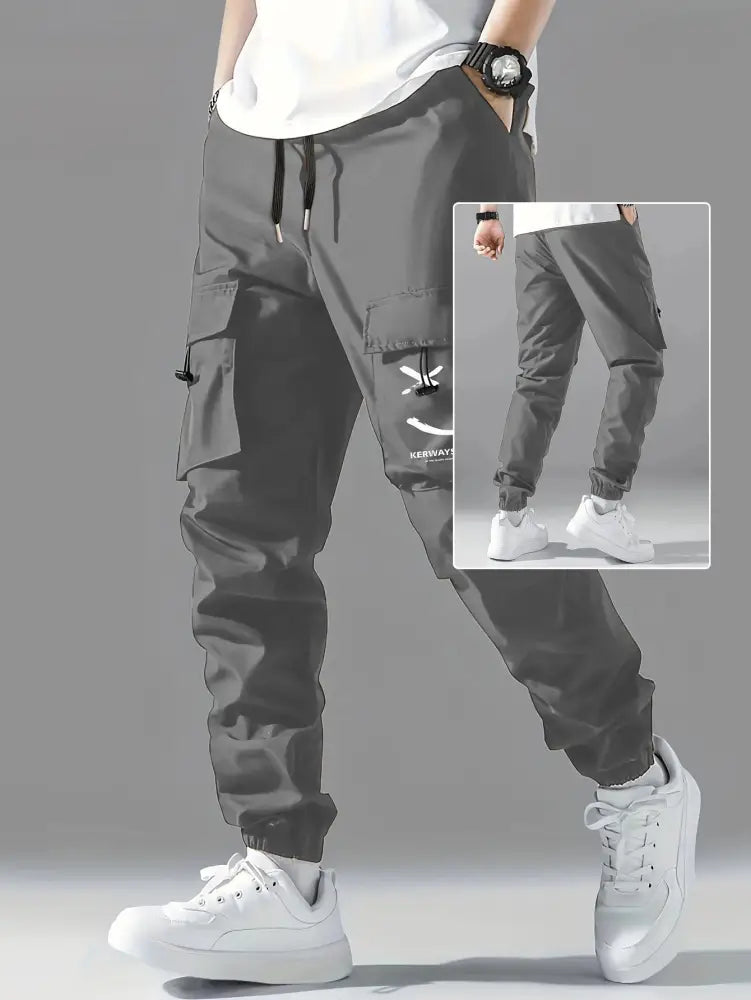 Men’s dark gray wear resistant cargo joggers with multiple pockets and a smiley face logo on the thigh