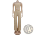 Beige satin strapless jumpsuit with wide leg high slit and cutout back featuring gold-toned decorative belt buckle
