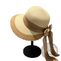Beige straw sun hat with woven scalloped brim and tan ribbon bow for summer beach wear