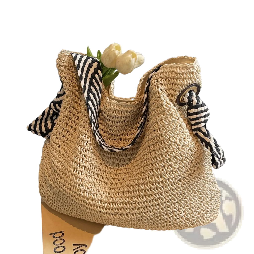 Beige woven straw tote bag with black and white striped fabric bow handles for casual use