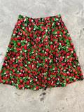 A vintage strawberry print cotton a line skirt with pockets featuring red strawberries and green leaves on dark fabric