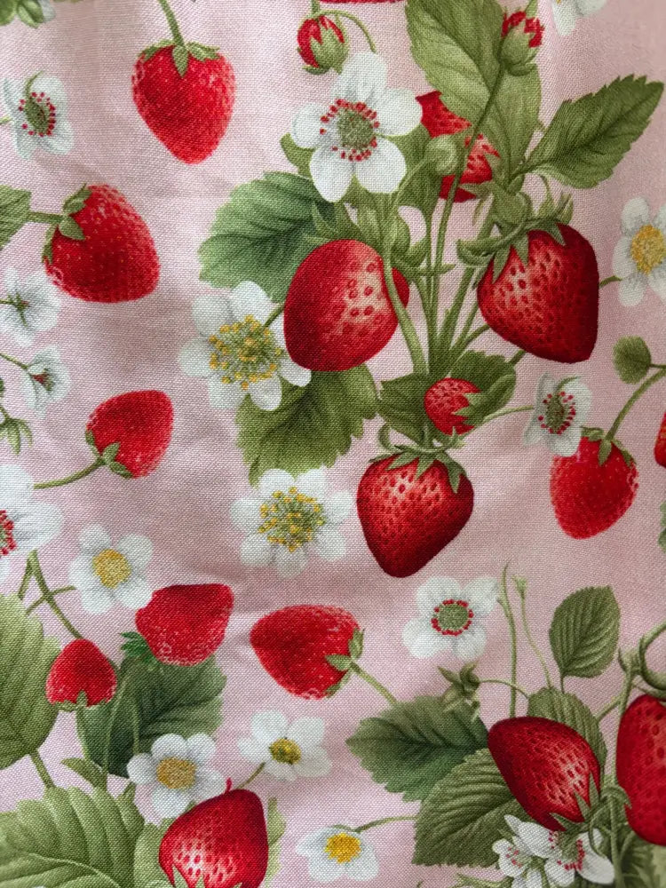 Retro strawberry print sleeveless cotton a-line dress with pink fabric featuring red strawberries green leaves and white flowers