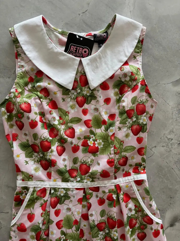 Retro strawberry print sleeveless cotton a-line dress in pink with white peter pan collar and matching waistband
